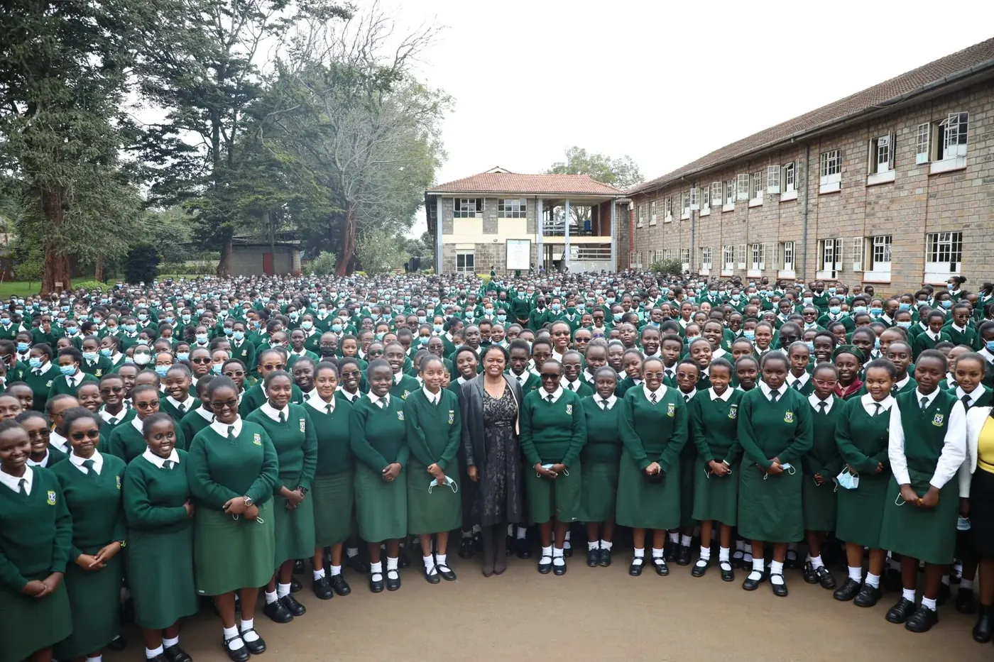Students gathered with a distinguished visitor to the school