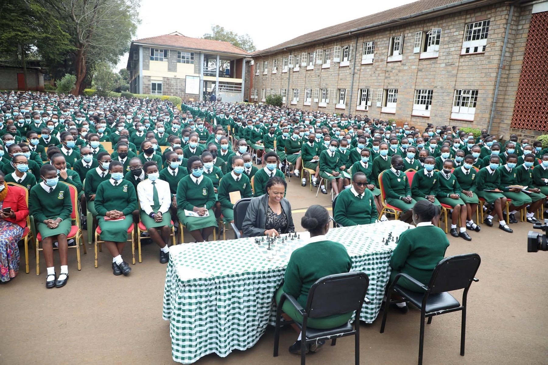 Hundreds of Alliance Girls' High School students in green uniform seated at a school assembly