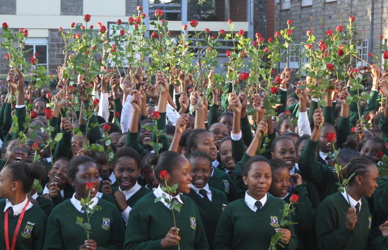Students celebrating together with red roses